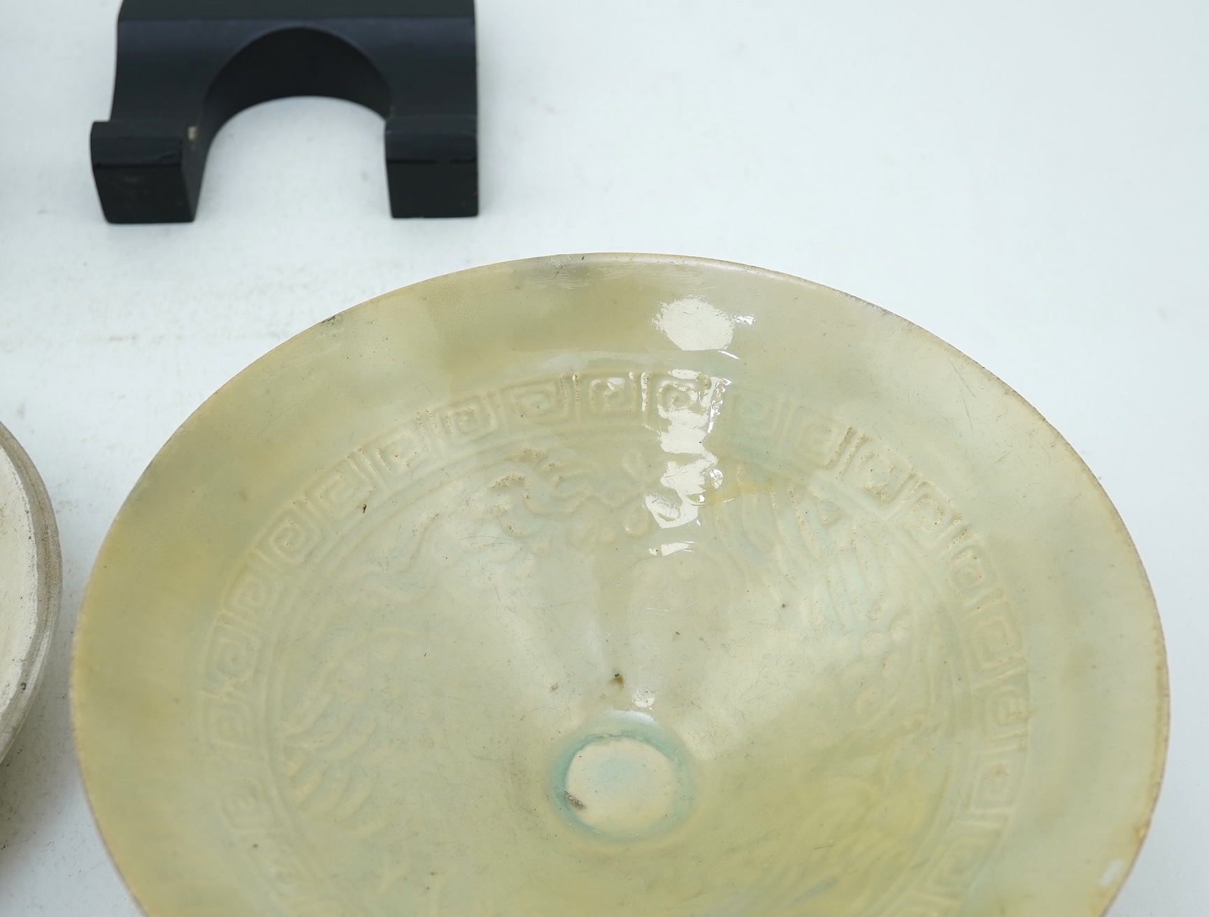 A Chinese Ding type circular dish, Song dynasty and a qingbai moulded conical bowl, Song-Yuan dynasty